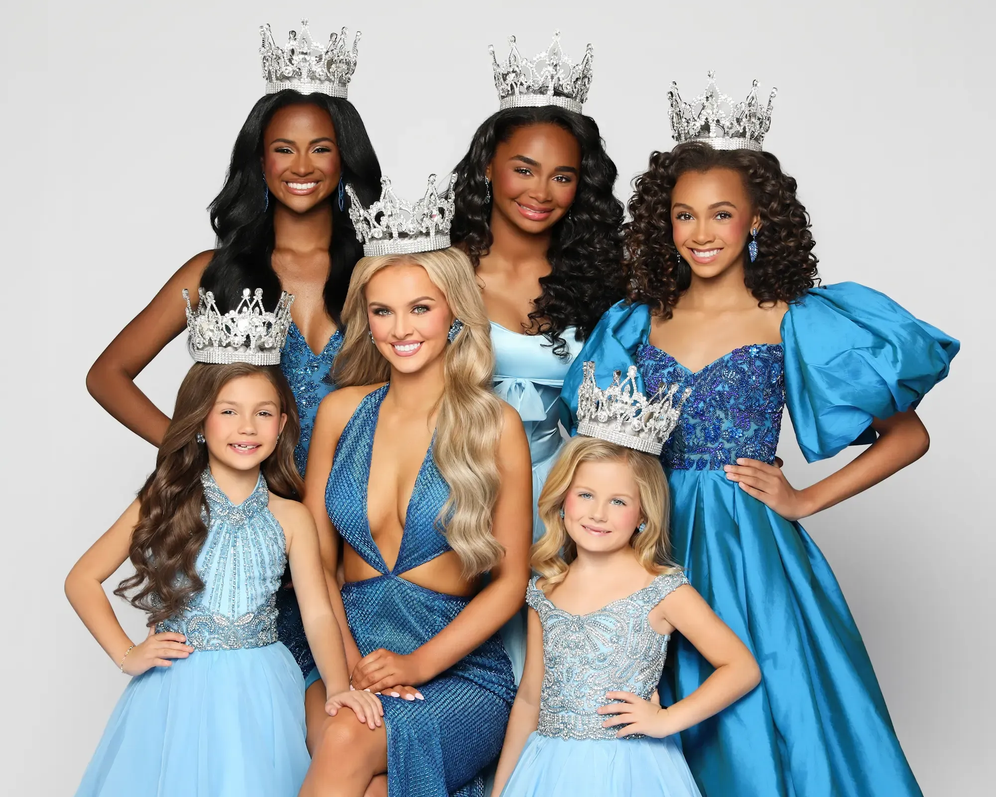 America's Ideal Miss national titleholders wearing their crowns
